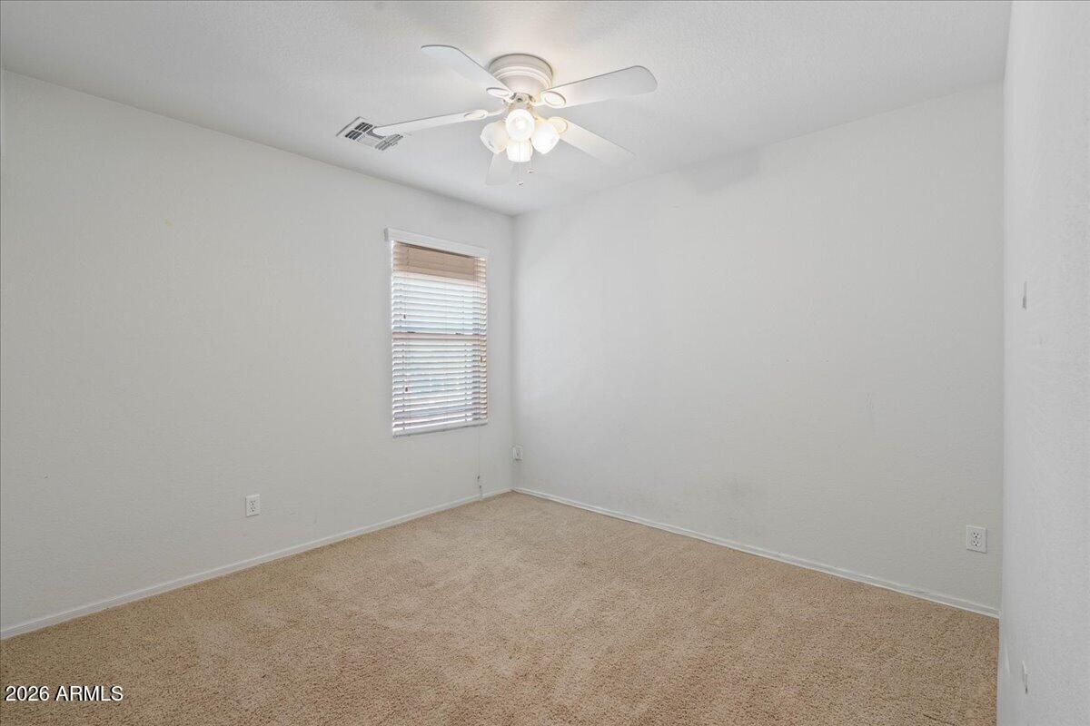 1255 South Rialto, Unit 106 Mesa, AZ 85209 - Photo 21 of 32 an empty room with a chandelier fan and windows