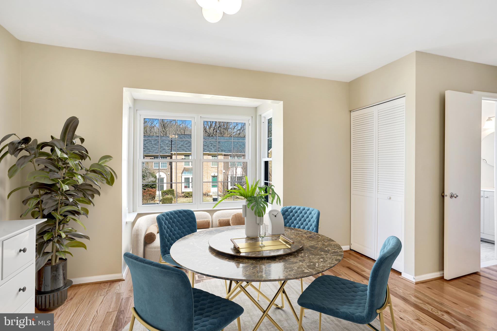 11440 Encore Drive Silver Spring, MD 20901 - Photo 12 of 36 a dining room with furniture potted plants and wooden floor
