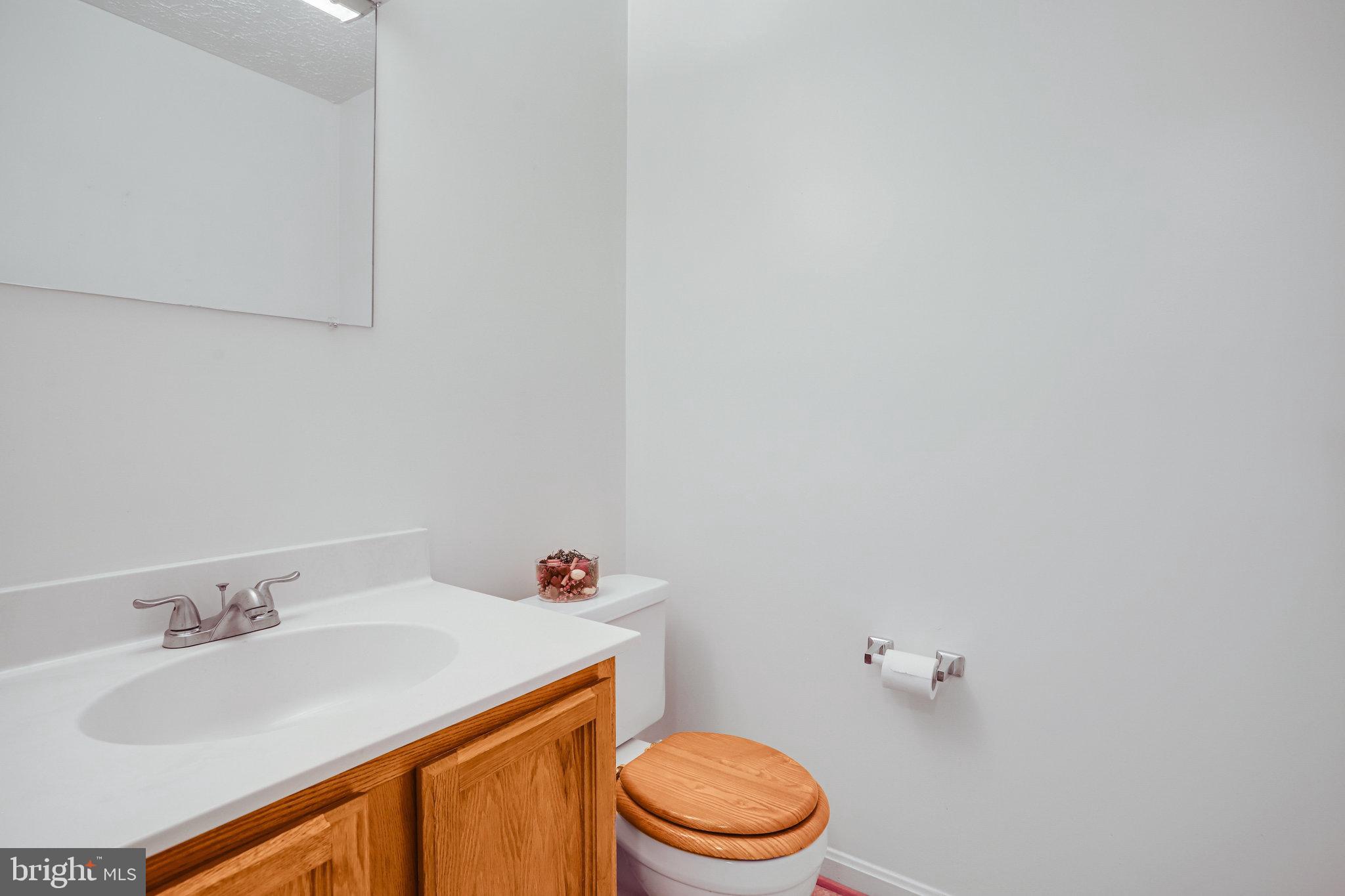 11440 Encore Drive Silver Spring, MD 20901 - Photo 29 of 36 a bathroom with a sink toilet and a mirror