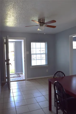 a view of a hallway with windows and chandelier
