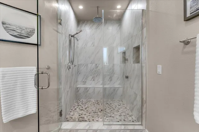 a bathroom with a glass shower door