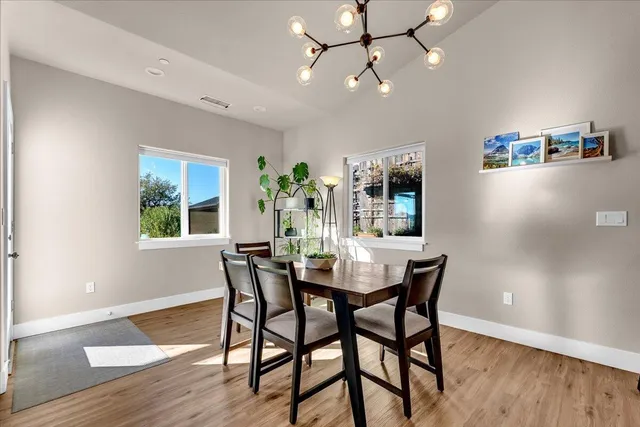 a view of a dining room with furniture window and wooden floor