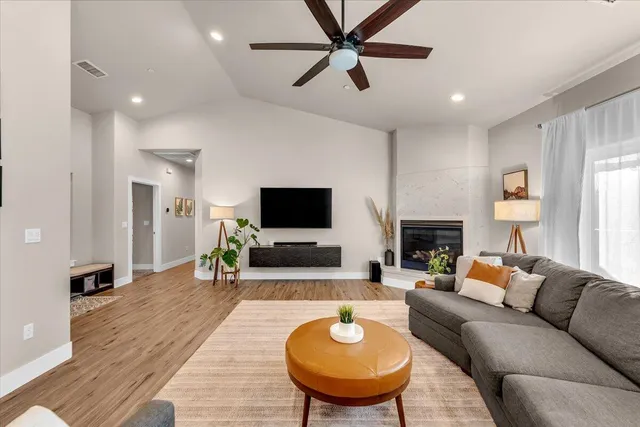 a living room with furniture a fireplace and a flat screen tv