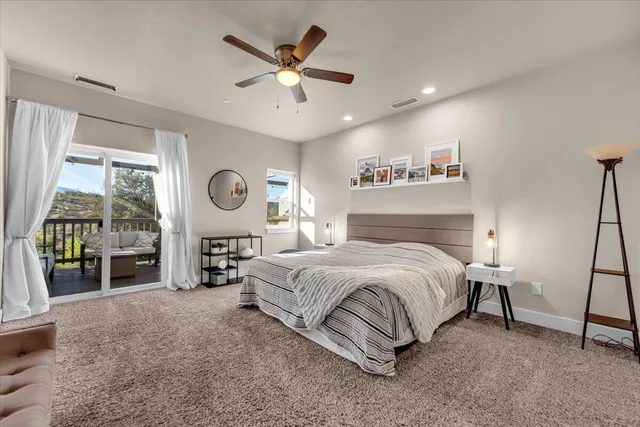 a spacious bedroom with a large bed and a large window