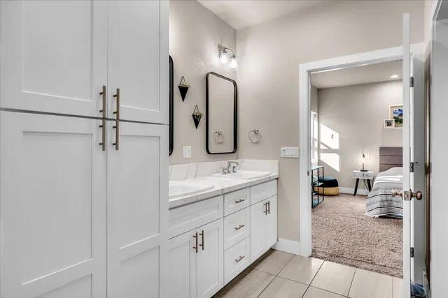 a spacious bathroom with a double vanity sink and a mirror