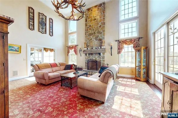 a living room with furniture a fireplace and a large window