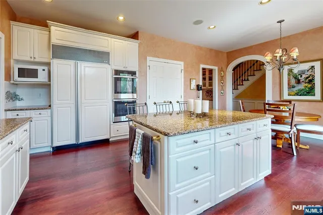 a bathroom with a double vanity sink a toilet and shower