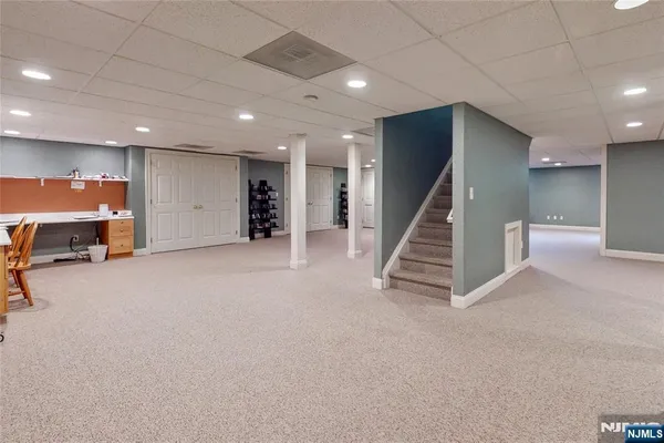 an empty room with wooden floor and stairs