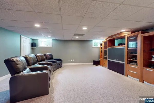a living room with furniture and a ceiling fan
