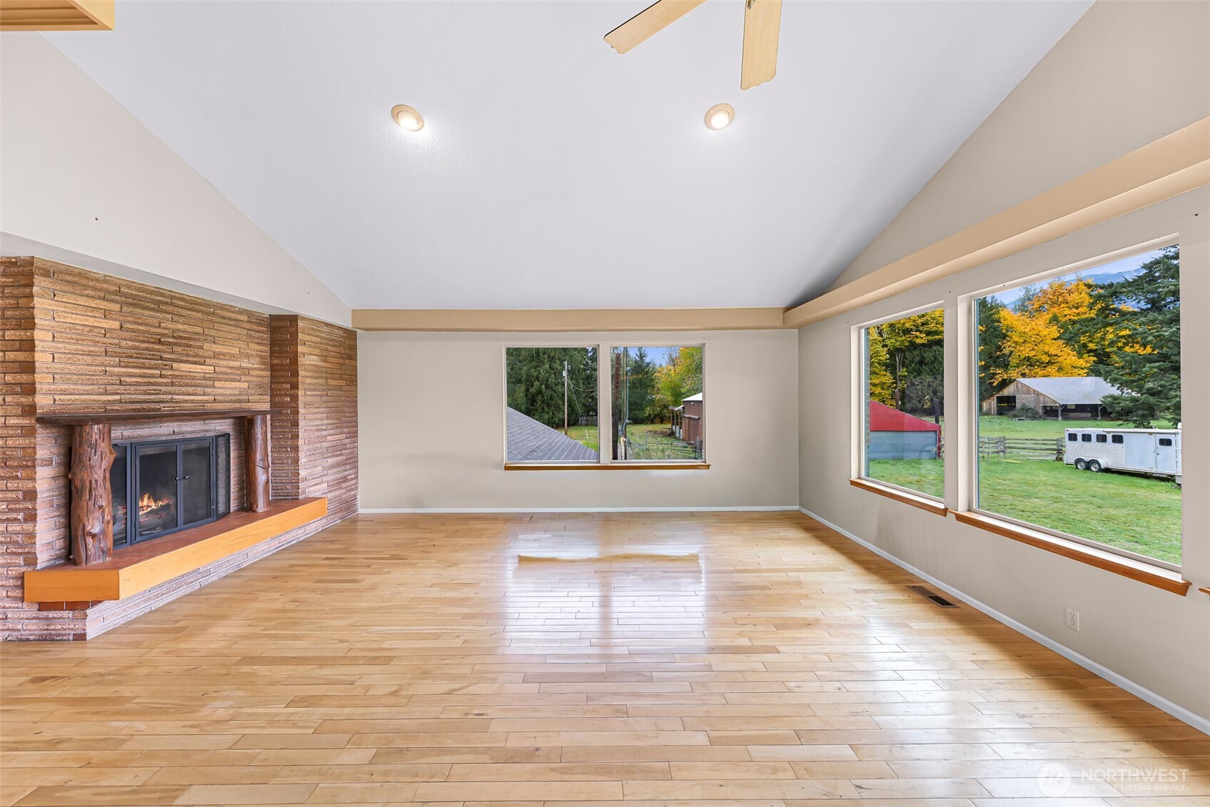 46003 Concrete Sauk Valley Road Concrete, WA 98237 - Photo 14 of 40 a view of empty room with wooden floor and fireplace