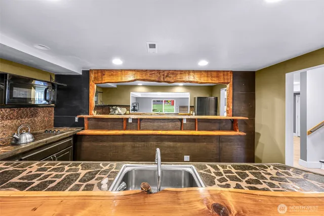 a kitchen with a sink and cabinets