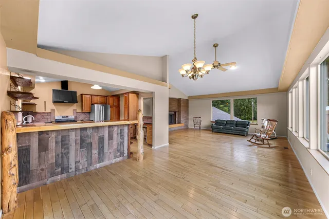 a kitchen with stainless steel appliances granite countertop a sink a stove and a refrigerator