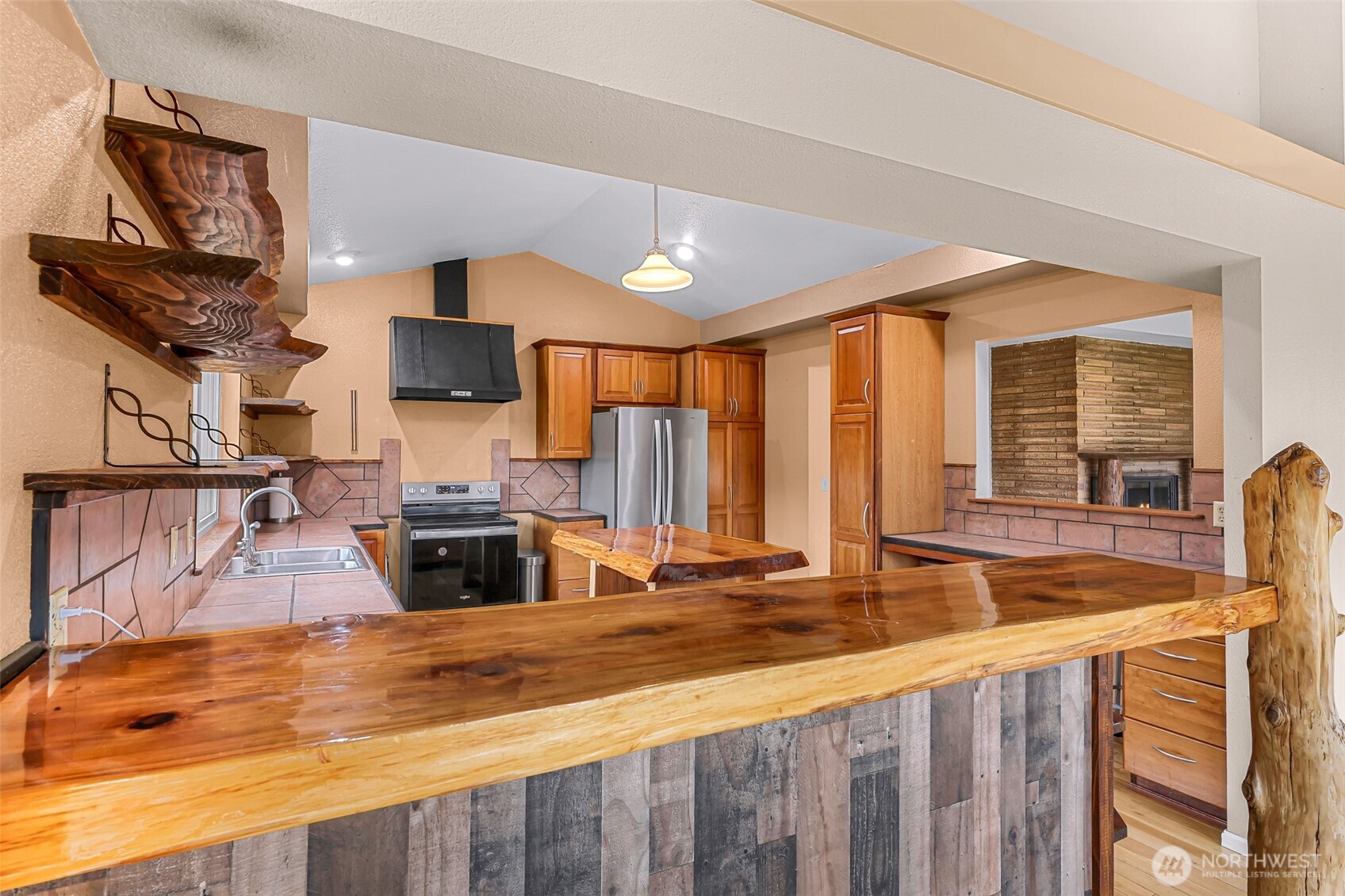 46003 Concrete Sauk Valley Road Concrete, WA 98237 - Photo 8 of 40 a view of living room with kitchen island furniture and a flat screen tv