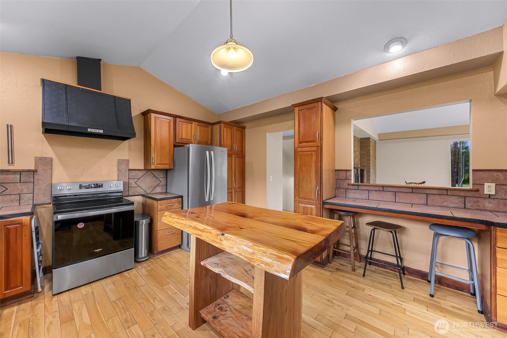 46003 Concrete Sauk Valley Road Concrete, WA 98237 - Photo 10 of 40 a kitchen with kitchen island a stove and a refrigerator