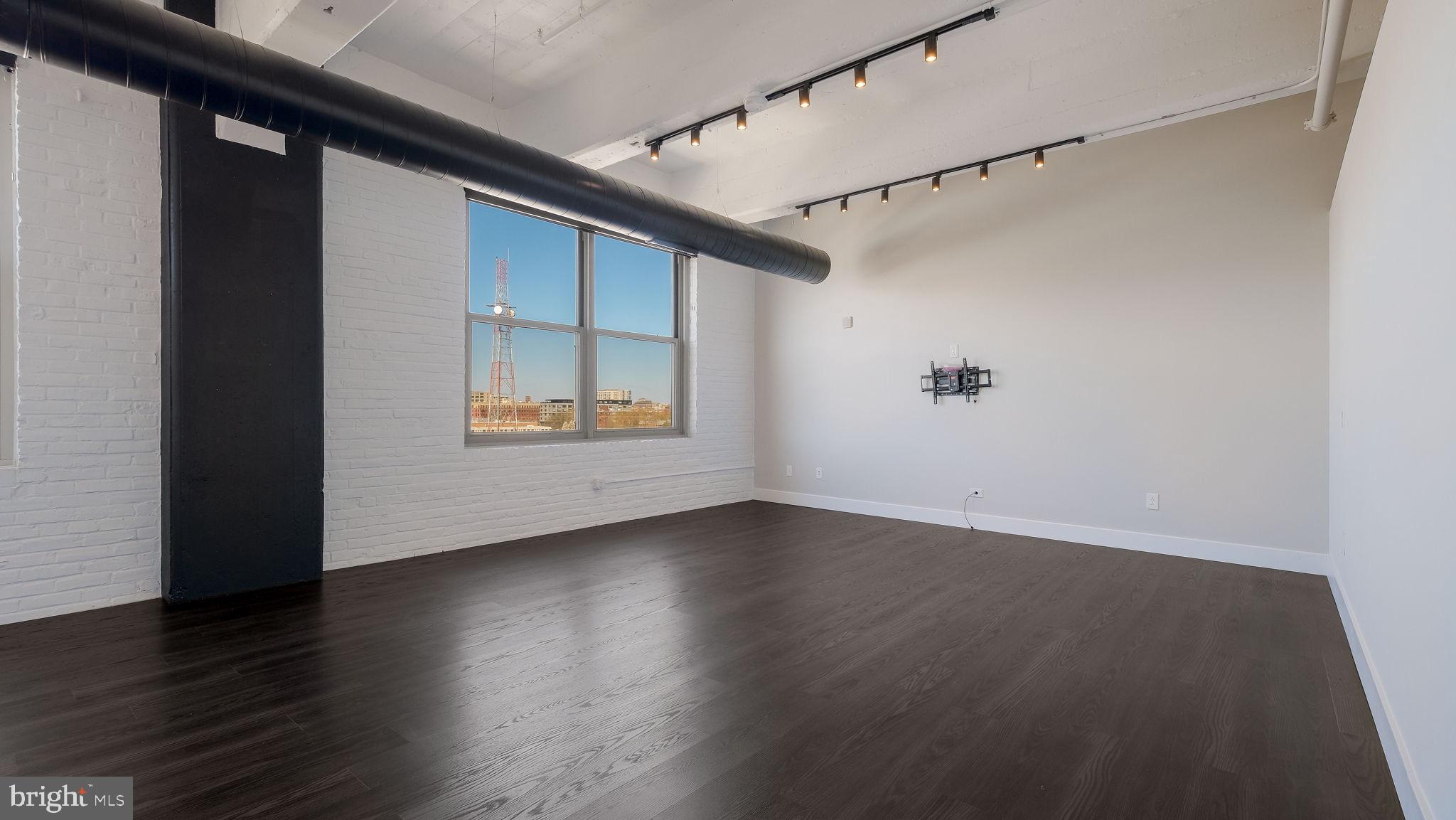 444 North 4th Street, Unit 601 Philadelphia, PA 19123 - Photo 13 of 38 an empty room with wooden floor and windows