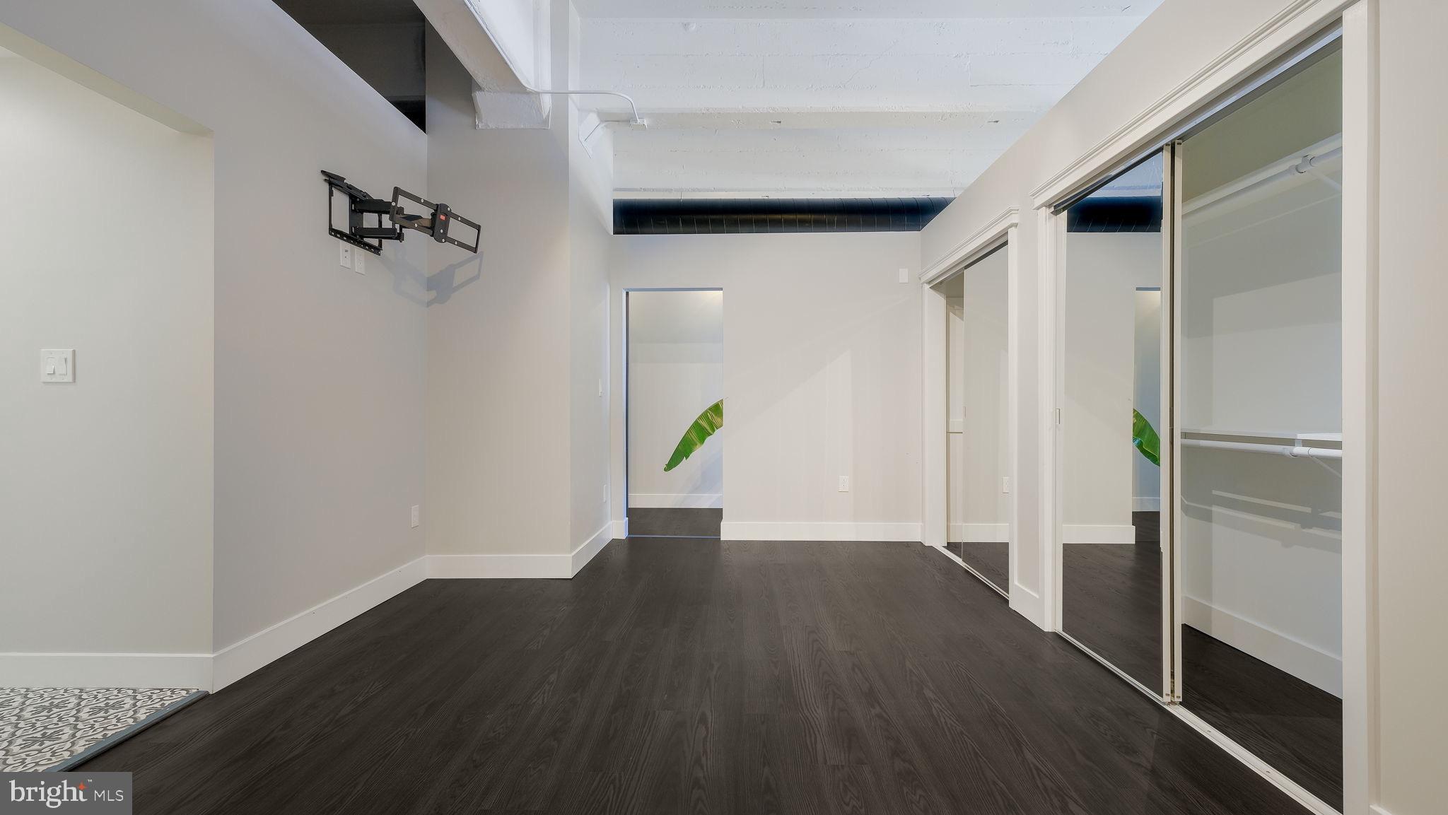 444 North 4th Street, Unit 601 Philadelphia, PA 19123 - Photo 18 of 38 a view of an empty room with wooden floor and a window