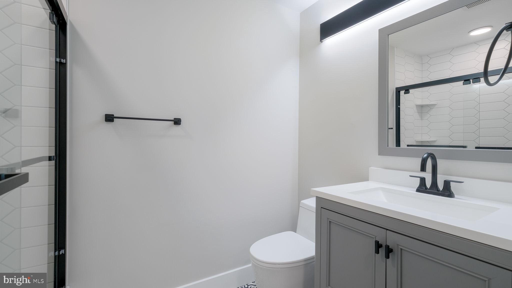 444 North 4th Street, Unit 601 Philadelphia, PA 19123 - Photo 24 of 38 a bathroom with a toilet a sink and mirror