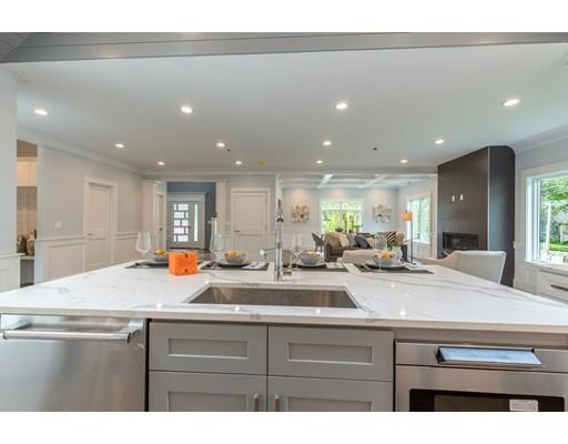 93 Pond Brook Road Newton, MA 02467 - Photo 12 of 33 a view of center island kitchen island a sink a refrigerator and a counter top