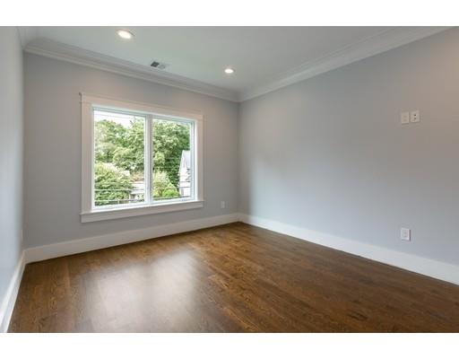 93 Pond Brook Road Newton, MA 02467 - Photo 22 of 33 a view of an empty room with wooden floor and a window