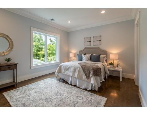 93 Pond Brook Road Newton, MA 02467 - Photo 23 of 33 a bedroom with a bed lamp and a large window