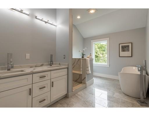 93 Pond Brook Road Newton, MA 02467 - Photo 25 of 33 a spacious bathroom with a granite countertop sink a toilet and a mirror