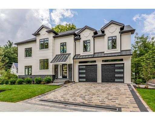 93 Pond Brook Road Newton, MA 02467 - Photo 4 of 33 a front view of a house with a yard and garage