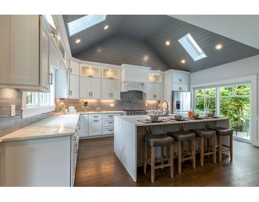 93 Pond Brook Road Newton, MA 02467 - Photo 10 of 33 a kitchen with stainless steel appliances granite countertop a sink and cabinets