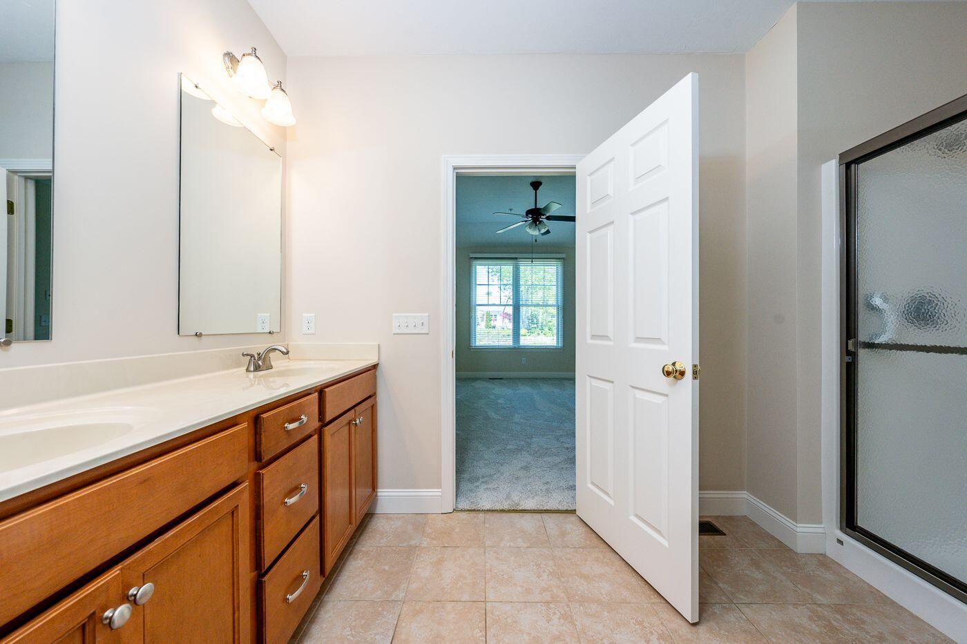 45 Grey Hawk Drive Mashpee, MA 02649 - Photo 11 of 23 a bathroom with a double vanity sink and a mirror