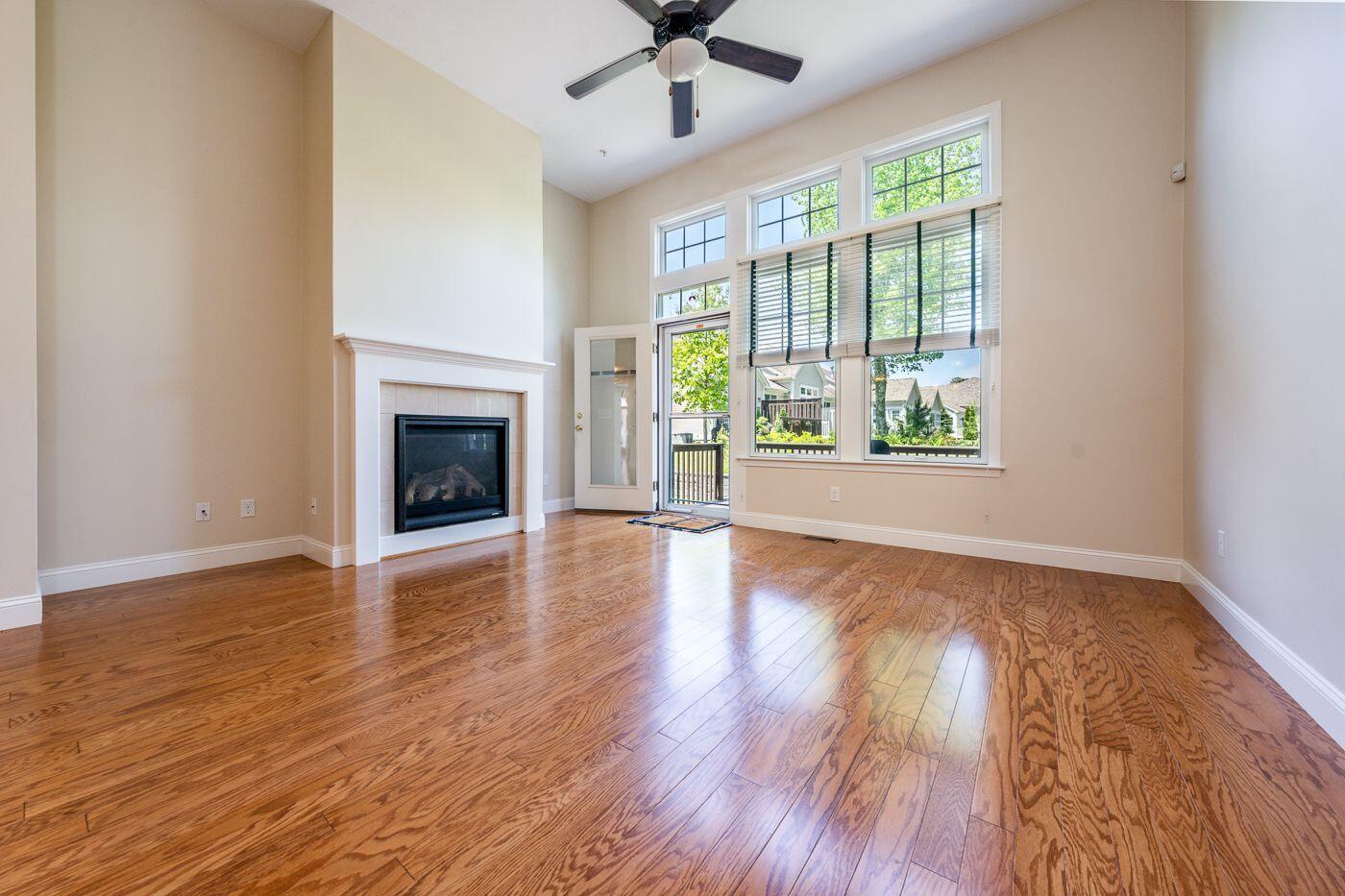 45 Grey Hawk Drive Mashpee, MA 02649 - Photo 5 of 23 wooden floor fireplace and windows in an empty room