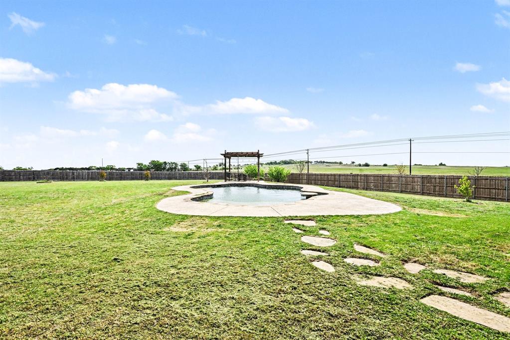 104 Stanford Lane Springtown, TX 76082 - Photo 27 of 28 a view of a swimming pool and a yard