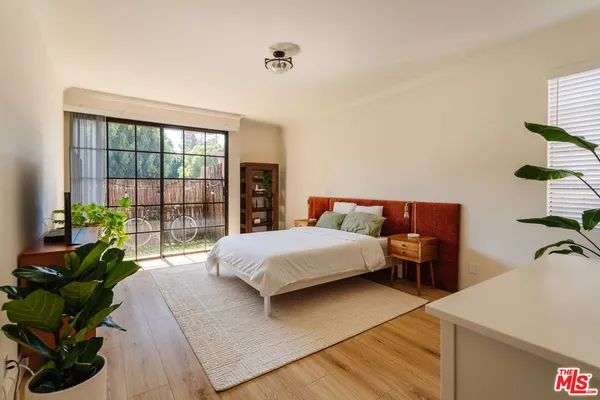 a bedroom with a bed and a large window