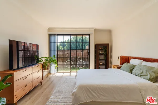 a bed sitting in a bedroom next to a window