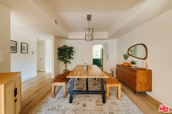 a living room with furniture a dining table with wooden floor