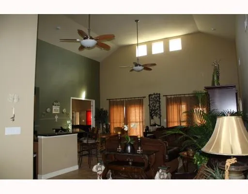 a living room with lots of furniture and a lamp