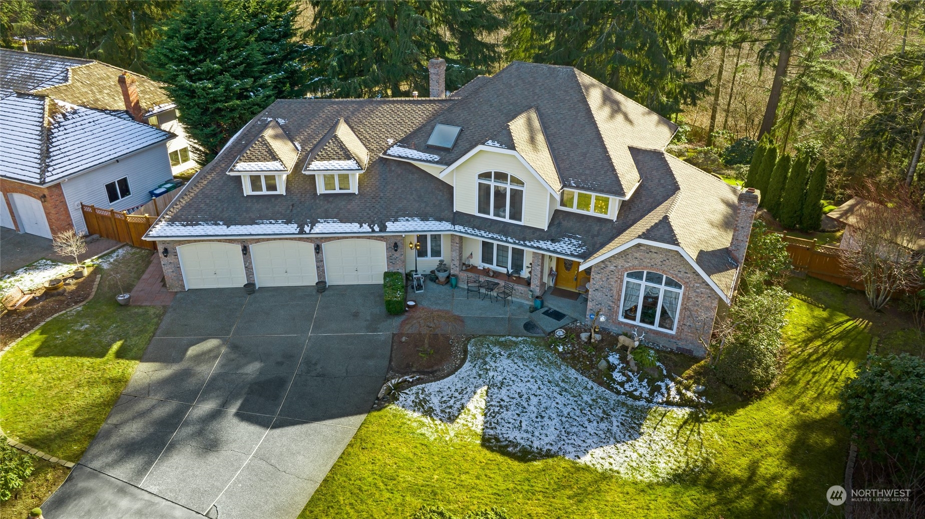 a aerial view of a brick house next to a yard