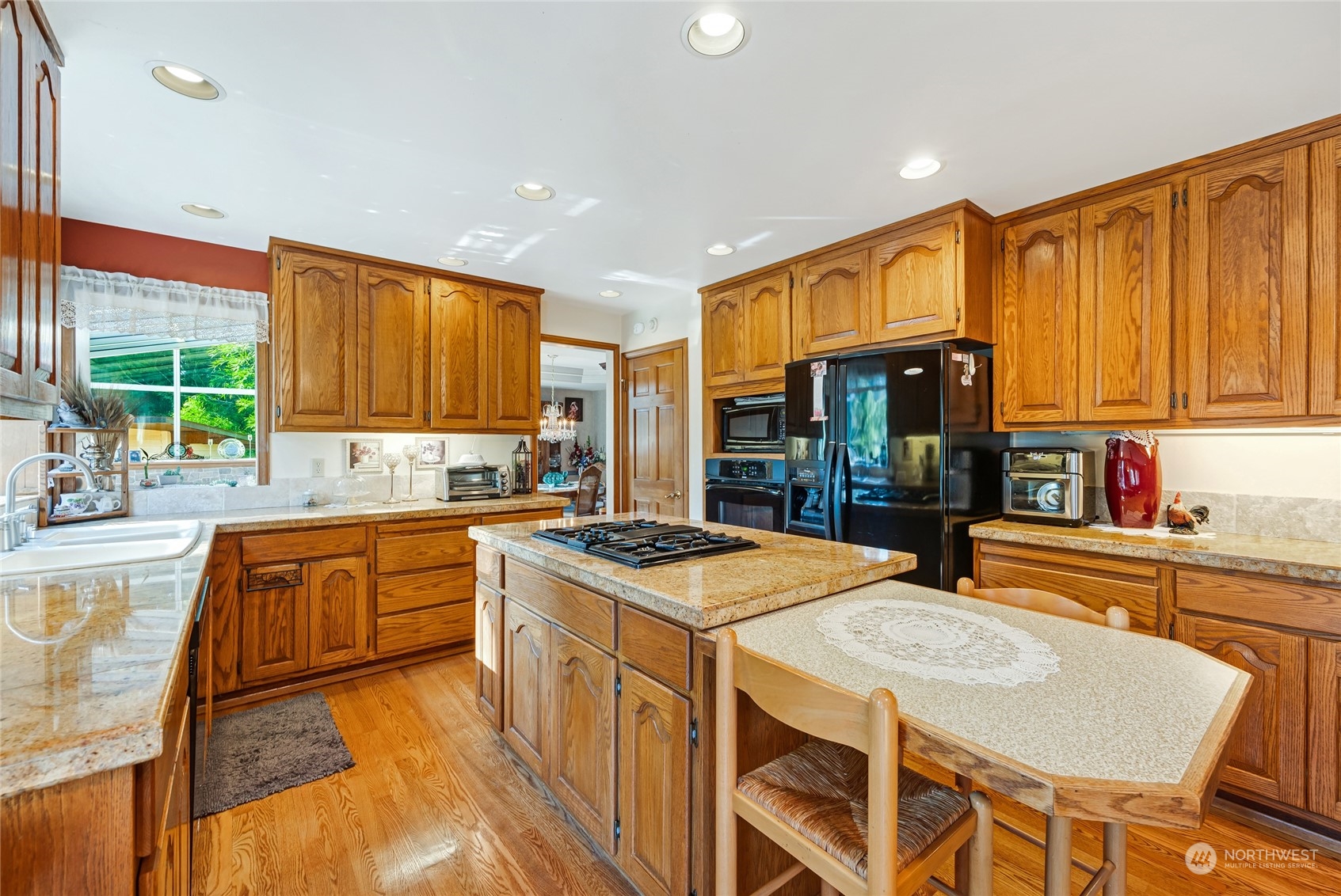 2914 184th Place Southeast Bothell, WA 98012 - Photo 11 of 40 a kitchen with stainless steel appliances granite countertop a stove a sink dishwasher and a refrigerator with wooden cabinets