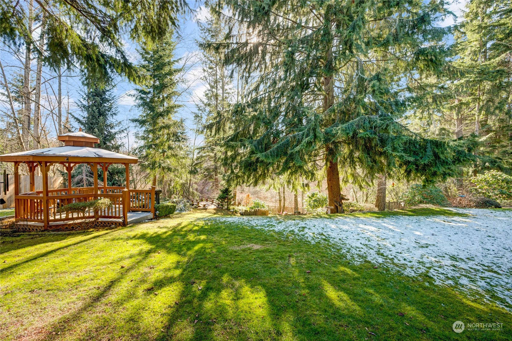 2914 184th Place Southeast Bothell, WA 98012 - Photo 33 of 40 a view of a yard with a table and chairs under an umbrella