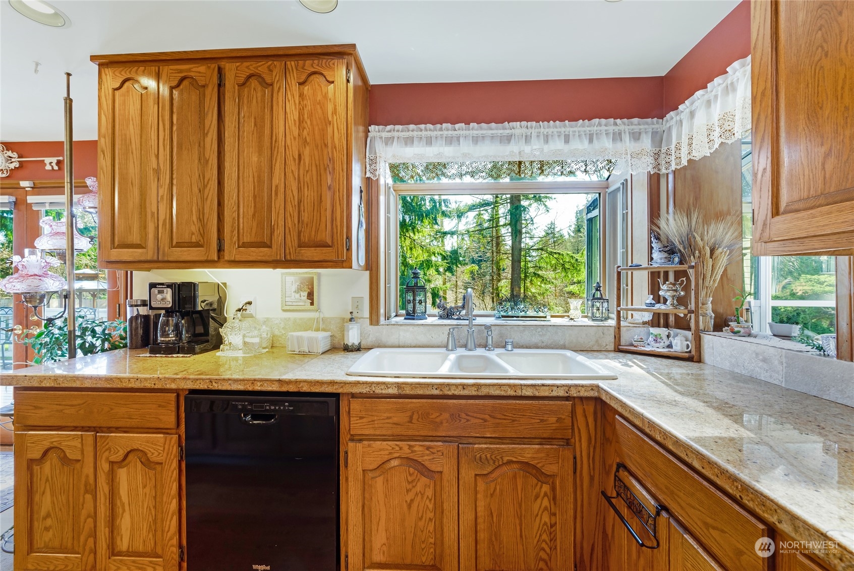 2914 184th Place Southeast Bothell, WA 98012 - Photo 10 of 40 a kitchen with stainless steel appliances granite countertop a sink a stove and next to a window