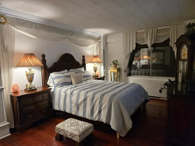a bedroom with a bed and window