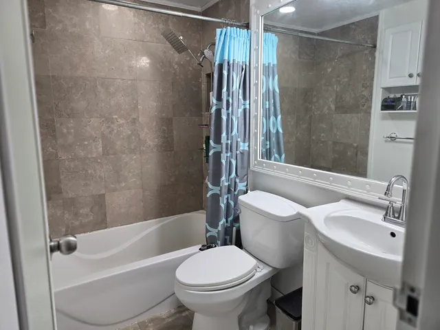 a bathroom with a sink toilet and shower