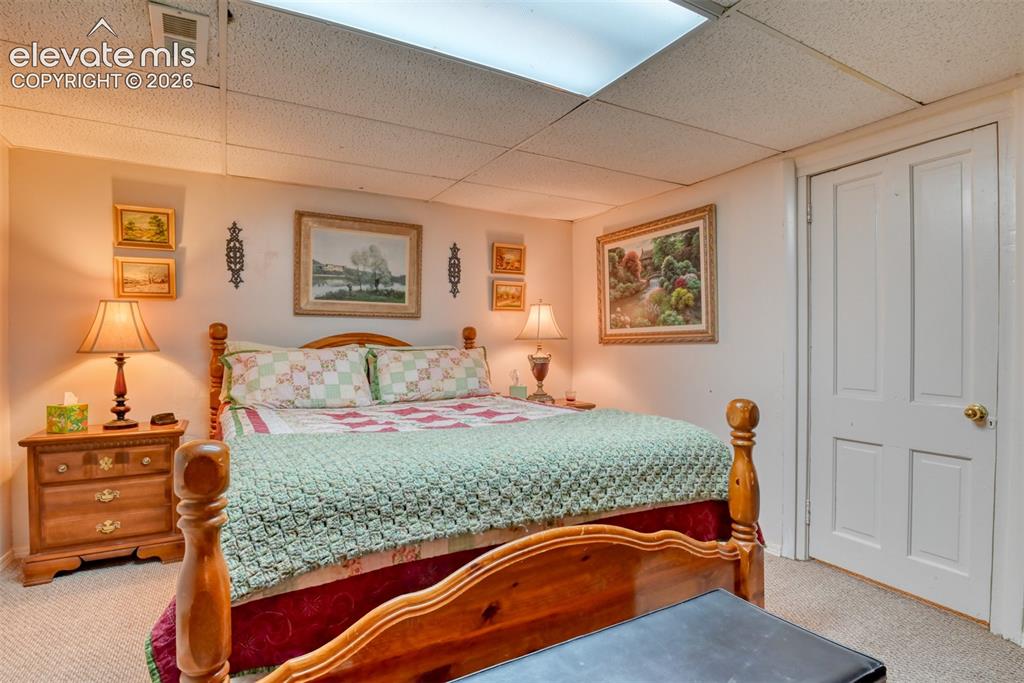 22558 Enoch Road Calhan, CO 80808 - Photo 45 of 50 a bedroom with a bed and dresser