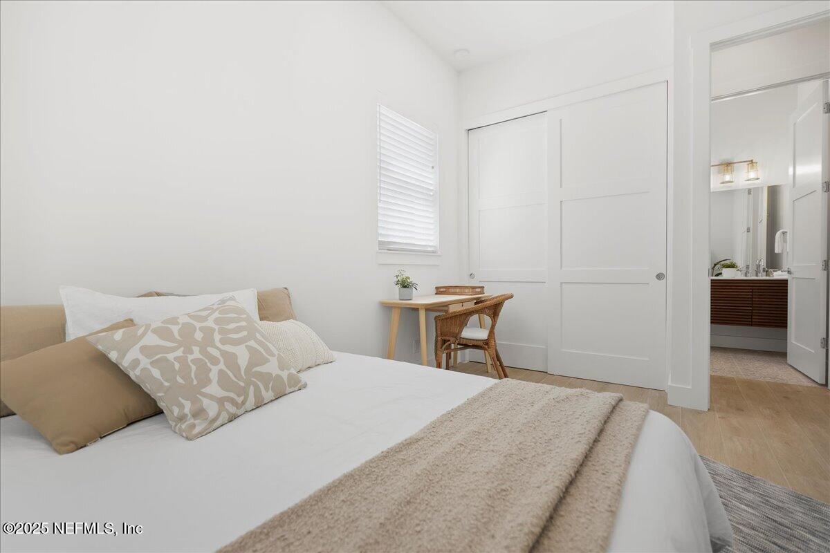168 Surfside Avenue St. Augustine, FL 32084 - Photo 12 of 28 a bedroom with a bed and a table in it