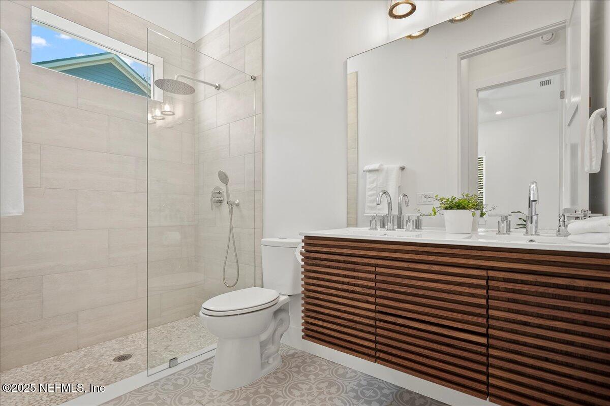 168 Surfside Avenue St. Augustine, FL 32084 - Photo 13 of 28 a bathroom with a sink a toilet and shower