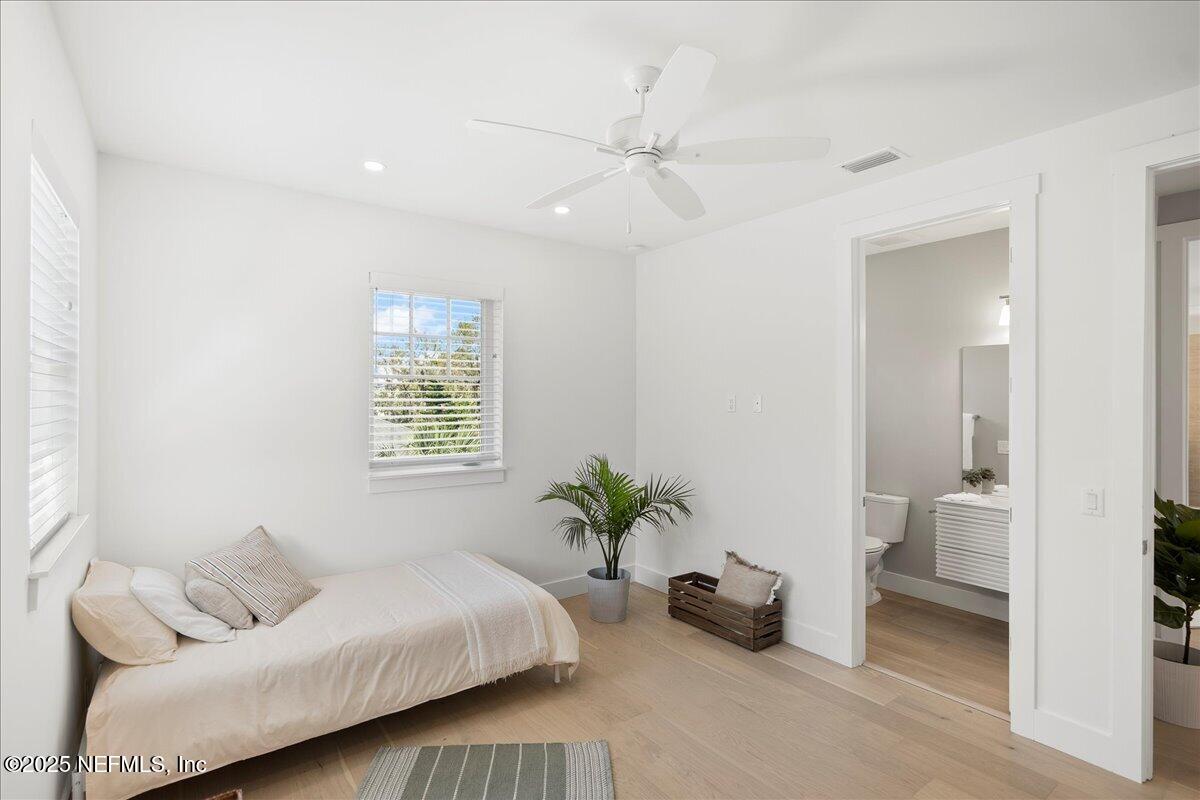 168 Surfside Avenue St. Augustine, FL 32084 - Photo 21 of 28 a bedroom with a bed and a couch