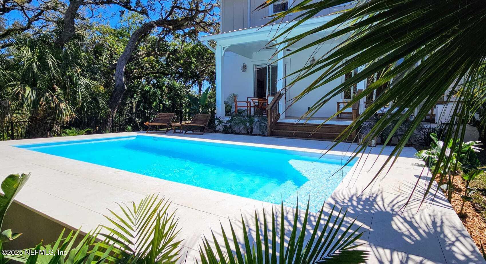 168 Surfside Avenue St. Augustine, FL 32084 - Photo 4 of 28 a view of a backyard with swimming pool