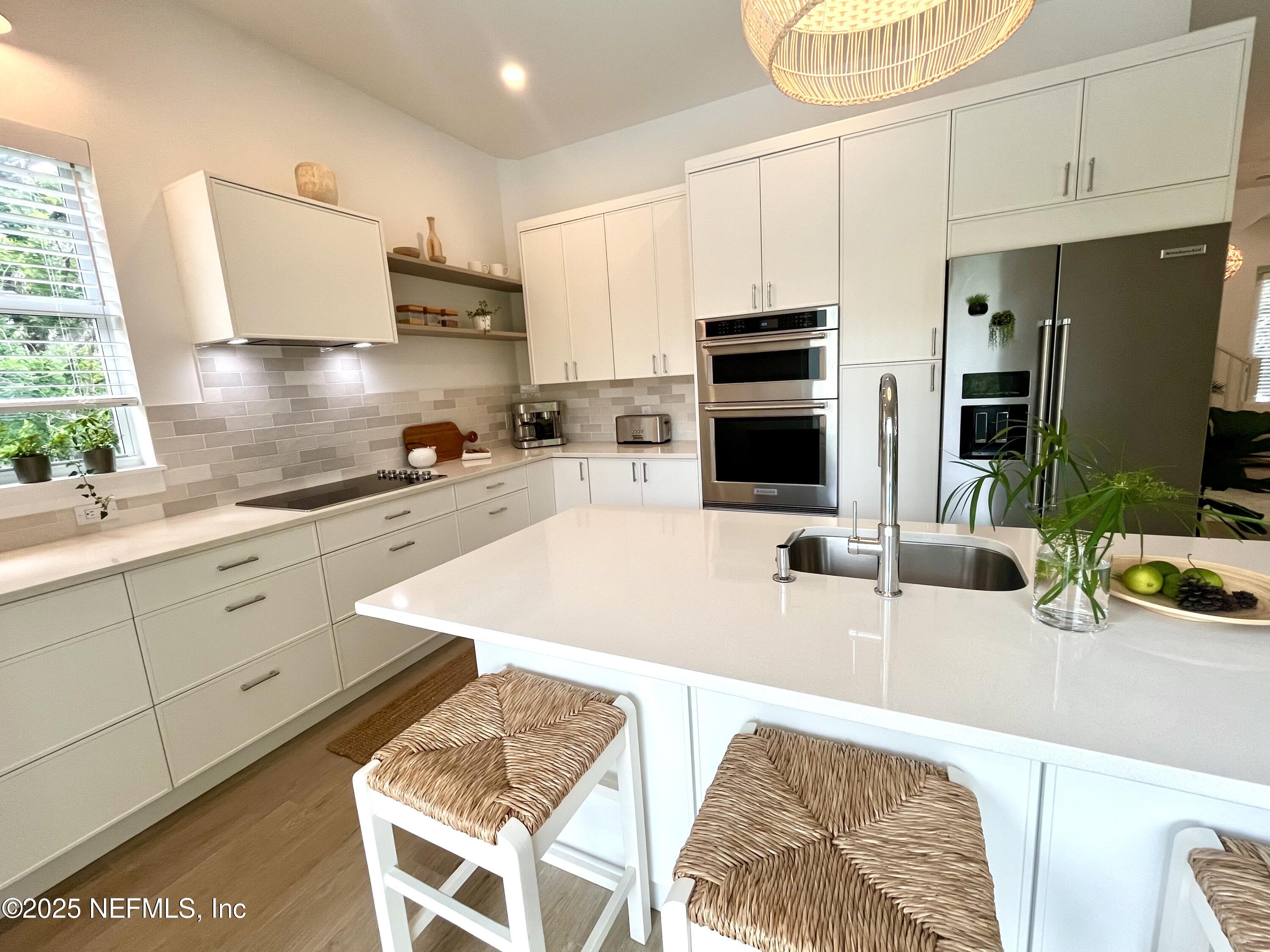 168 Surfside Avenue St. Augustine, FL 32084 - Photo 8 of 28 a kitchen with stainless steel appliances kitchen island granite countertop a sink and cabinets