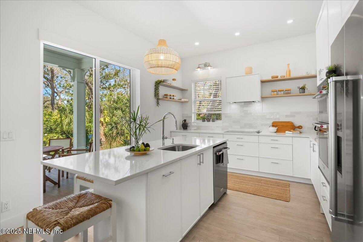 168 Surfside Avenue St. Augustine, FL 32084 - Photo 9 of 28 a kitchen with white cabinets and window