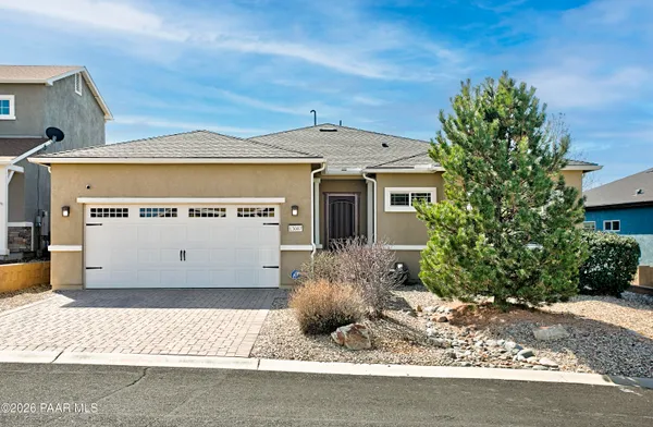 a view of a house with a small yard and plants