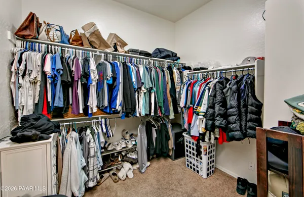 a view of walk in closet with clothes