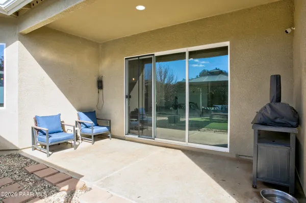 a bedroom with a bed and glass window